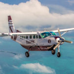 Getting to Caye Caulker by Tropic Air Plane flying above the sea